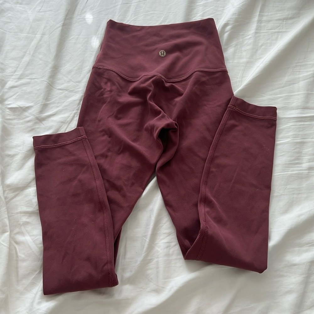 gold logo rose colored lululemon leggings